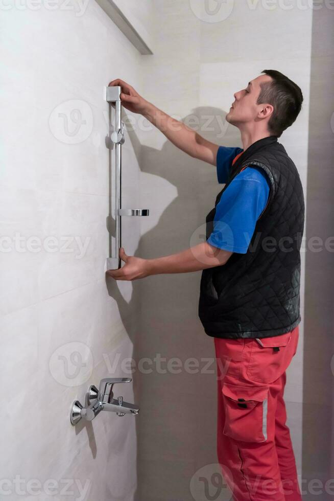 professional plumber working in a bathroom photo