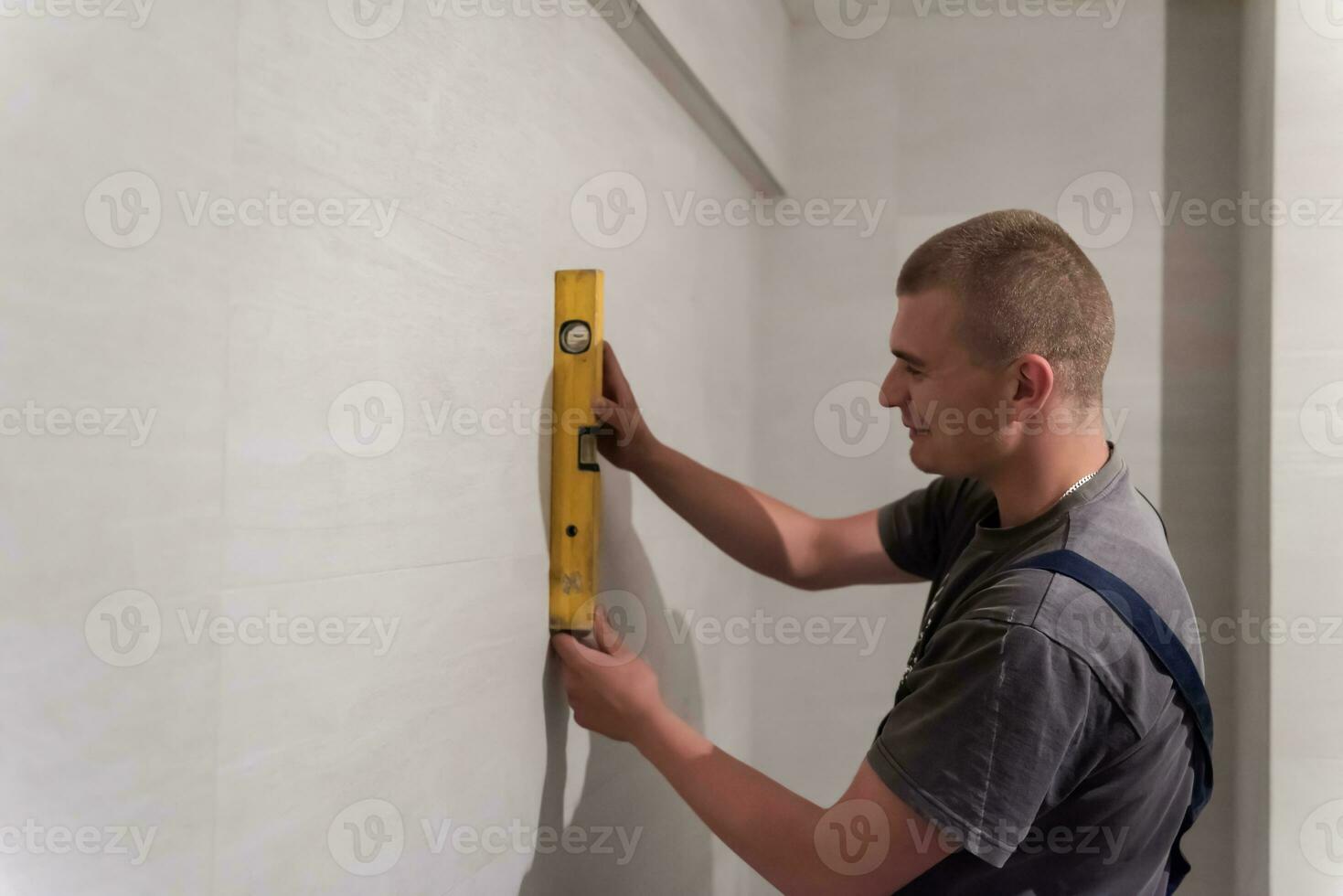 professional plumber using bubble level in a bathroom photo