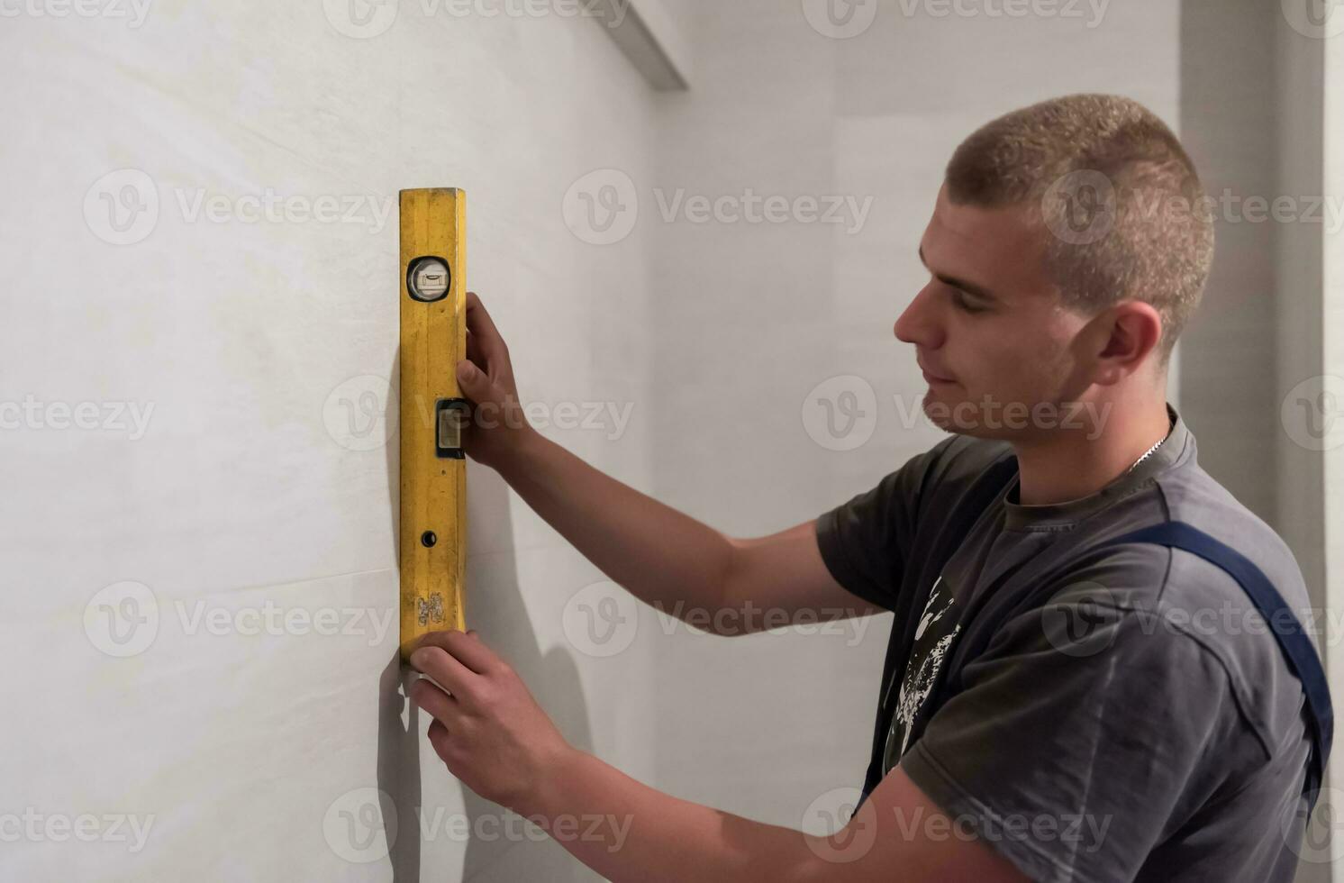 professional plumber using bubble level in a bathroom photo