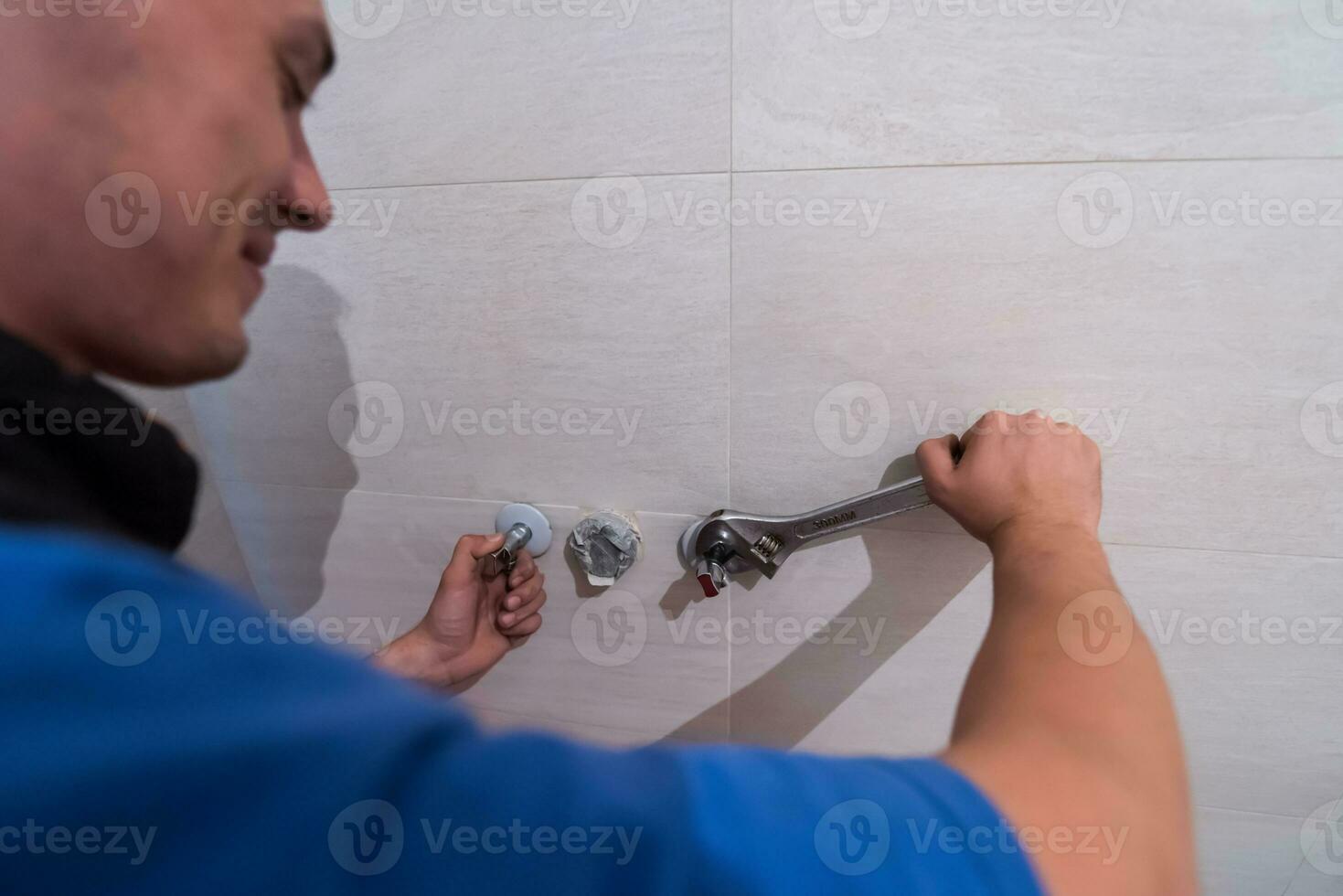 professional plumber working in a bathroom photo