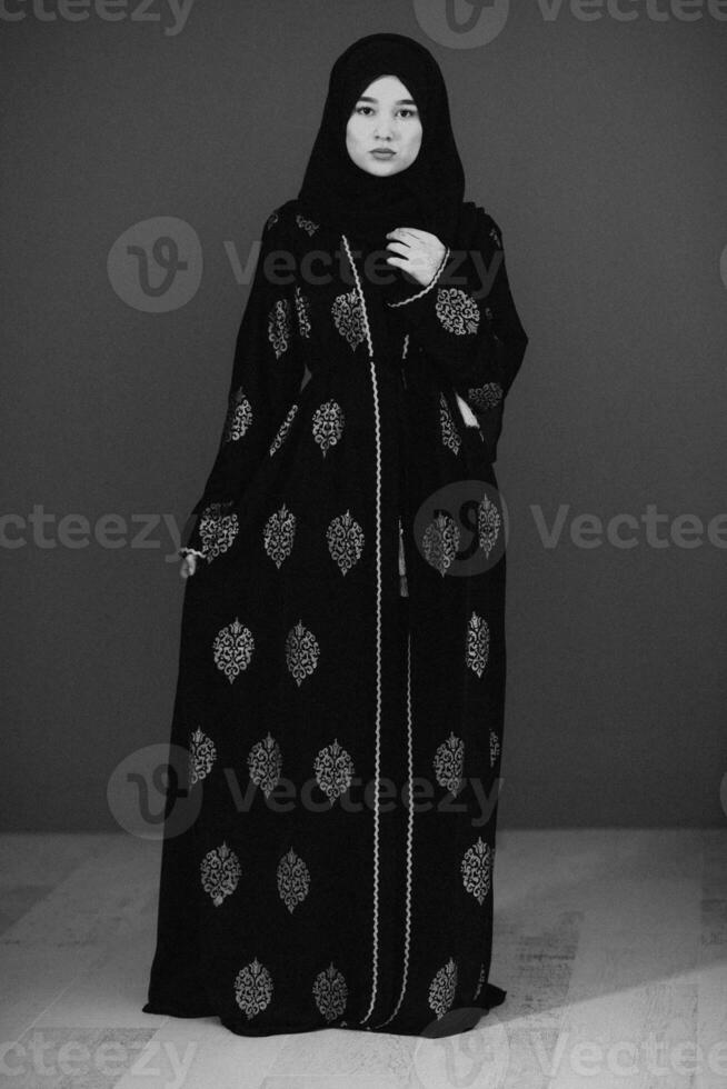 Black white photo of beautiful muslim woman in fashinable dress with hijab