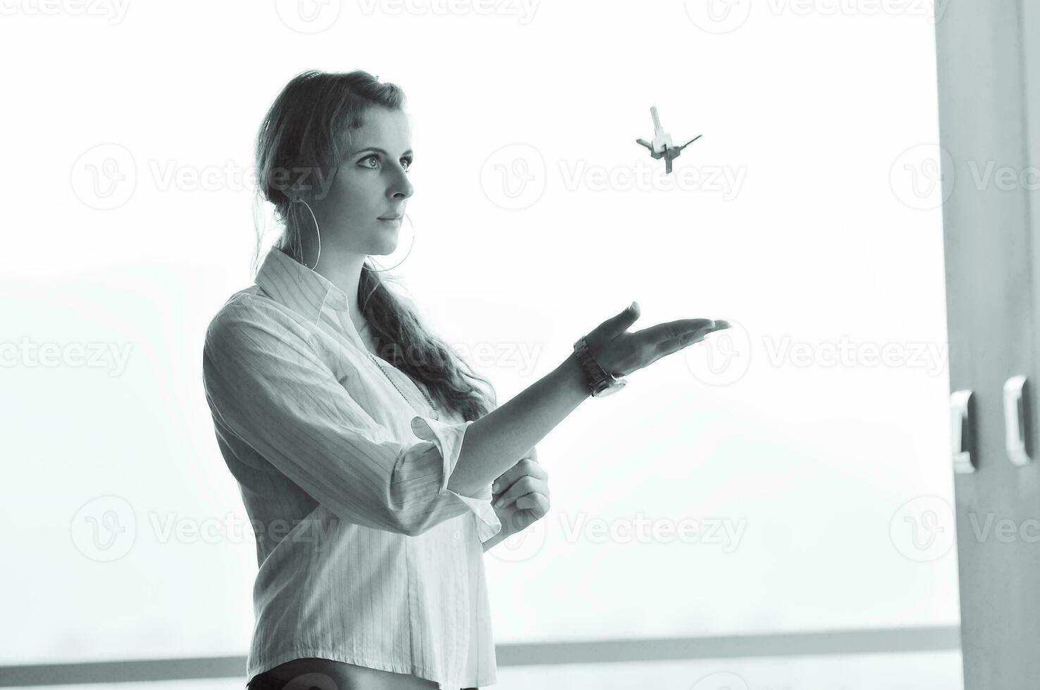 young woman throwing home keys in air photo