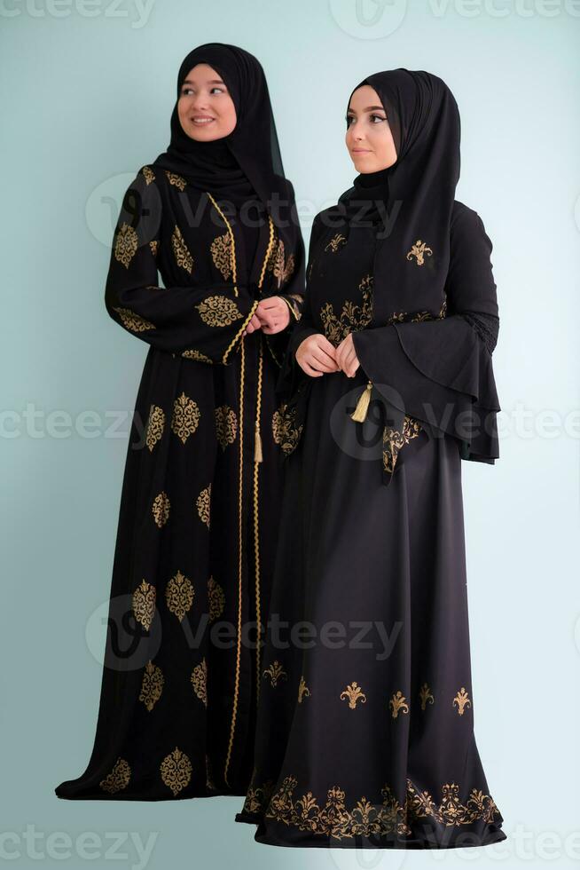 two hijab muslim woman on cyan background photo