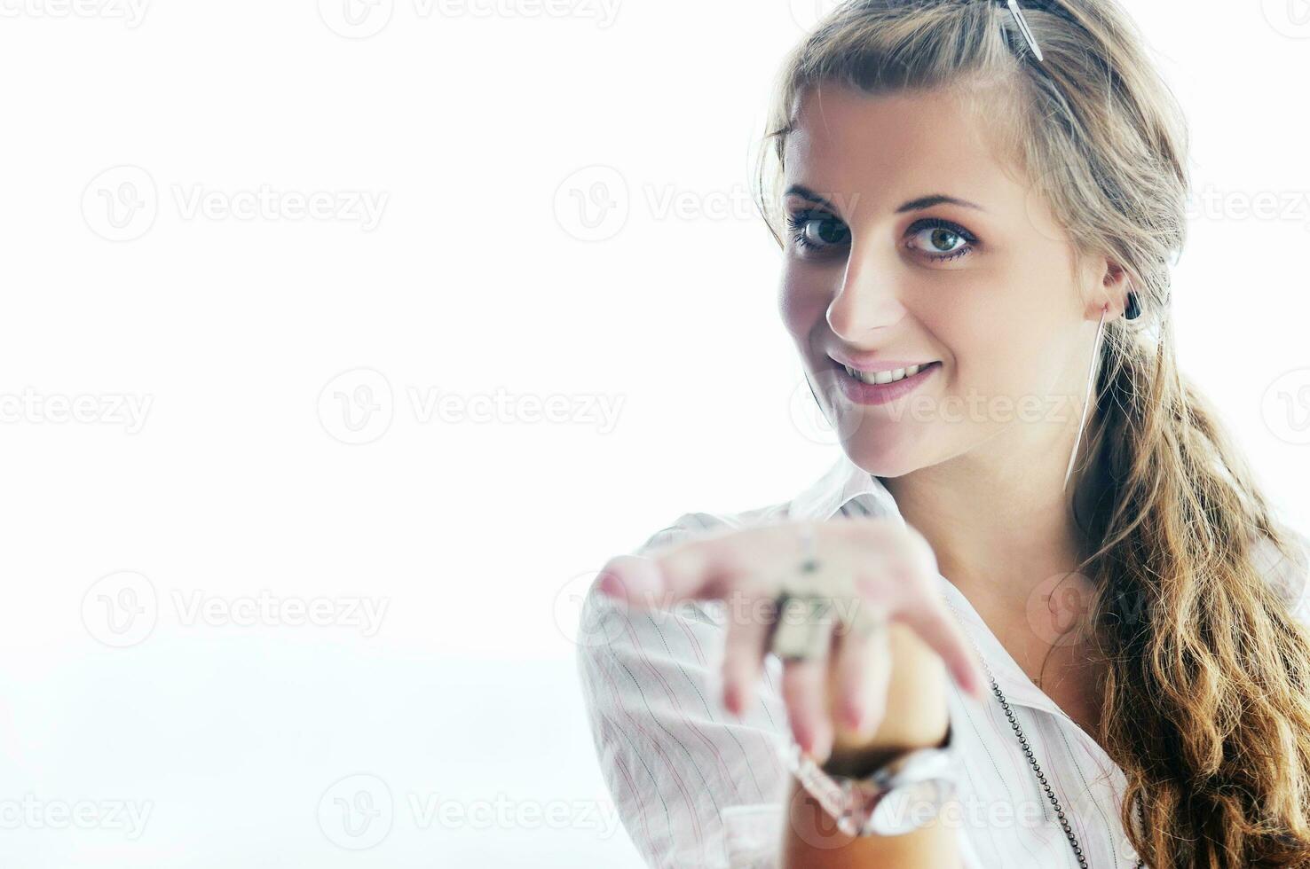 young woman throwing home keys in air photo