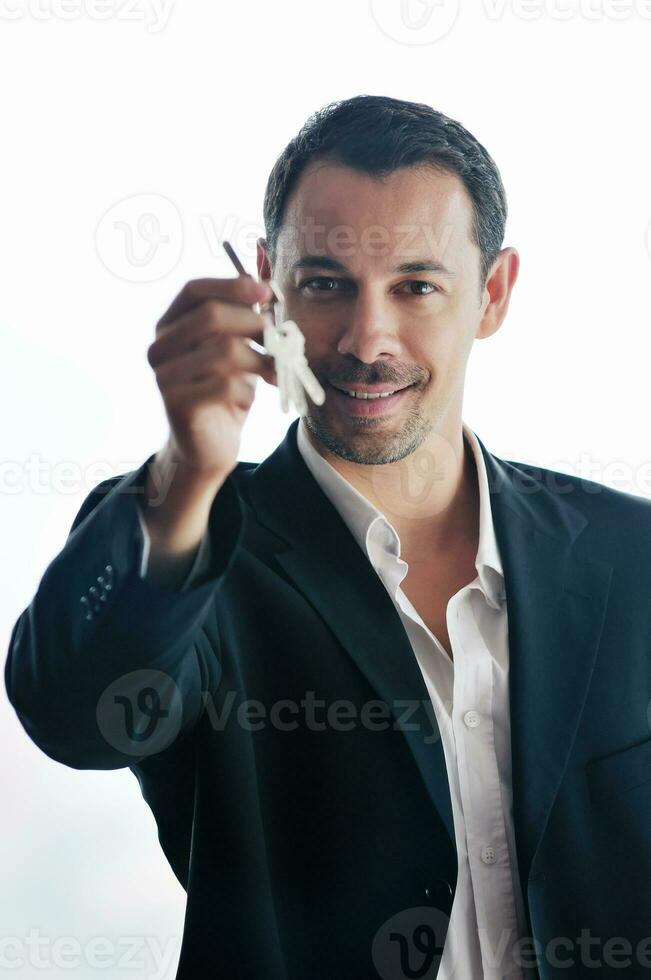 isolated business man hold keys photo