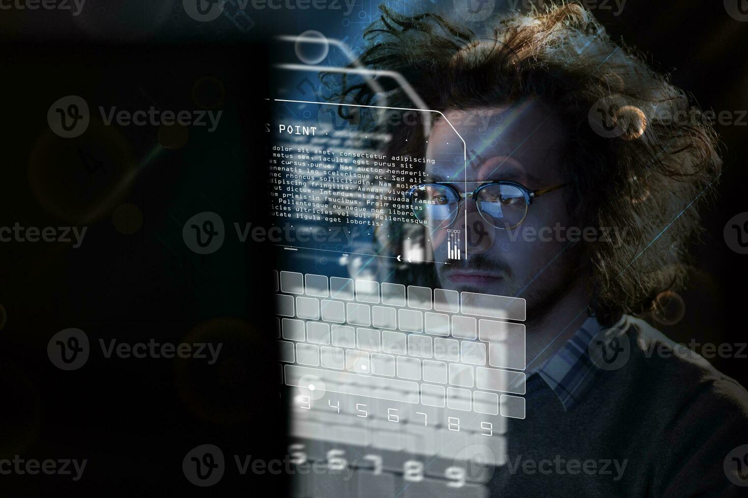 man working on computer in dark office photo