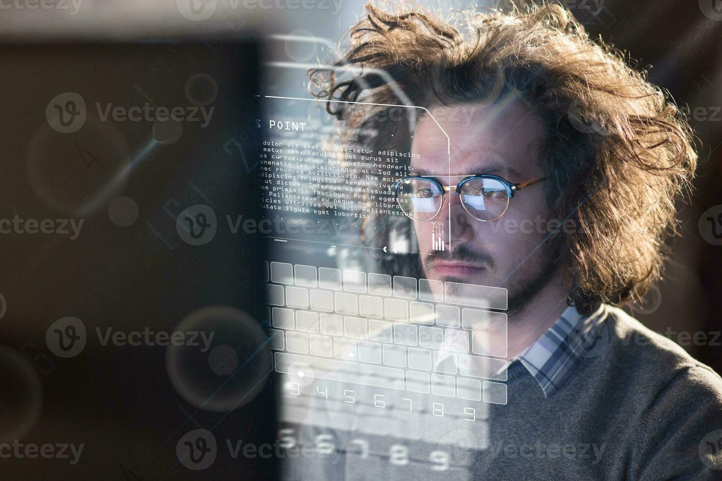 man working on computer in dark office photo