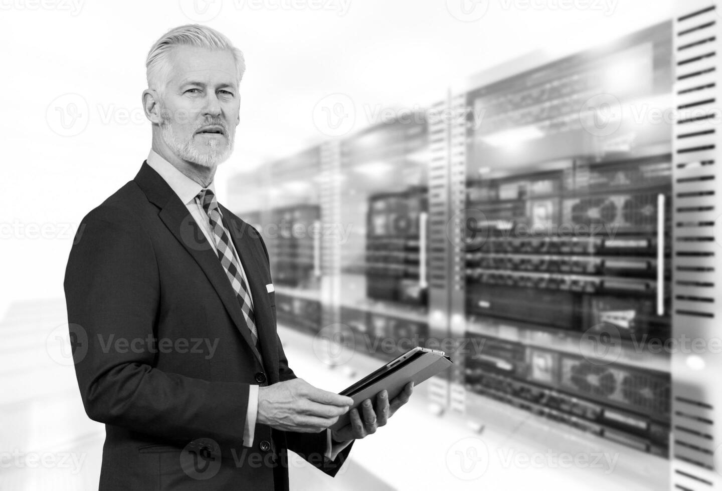 Senior businessman in server room photo