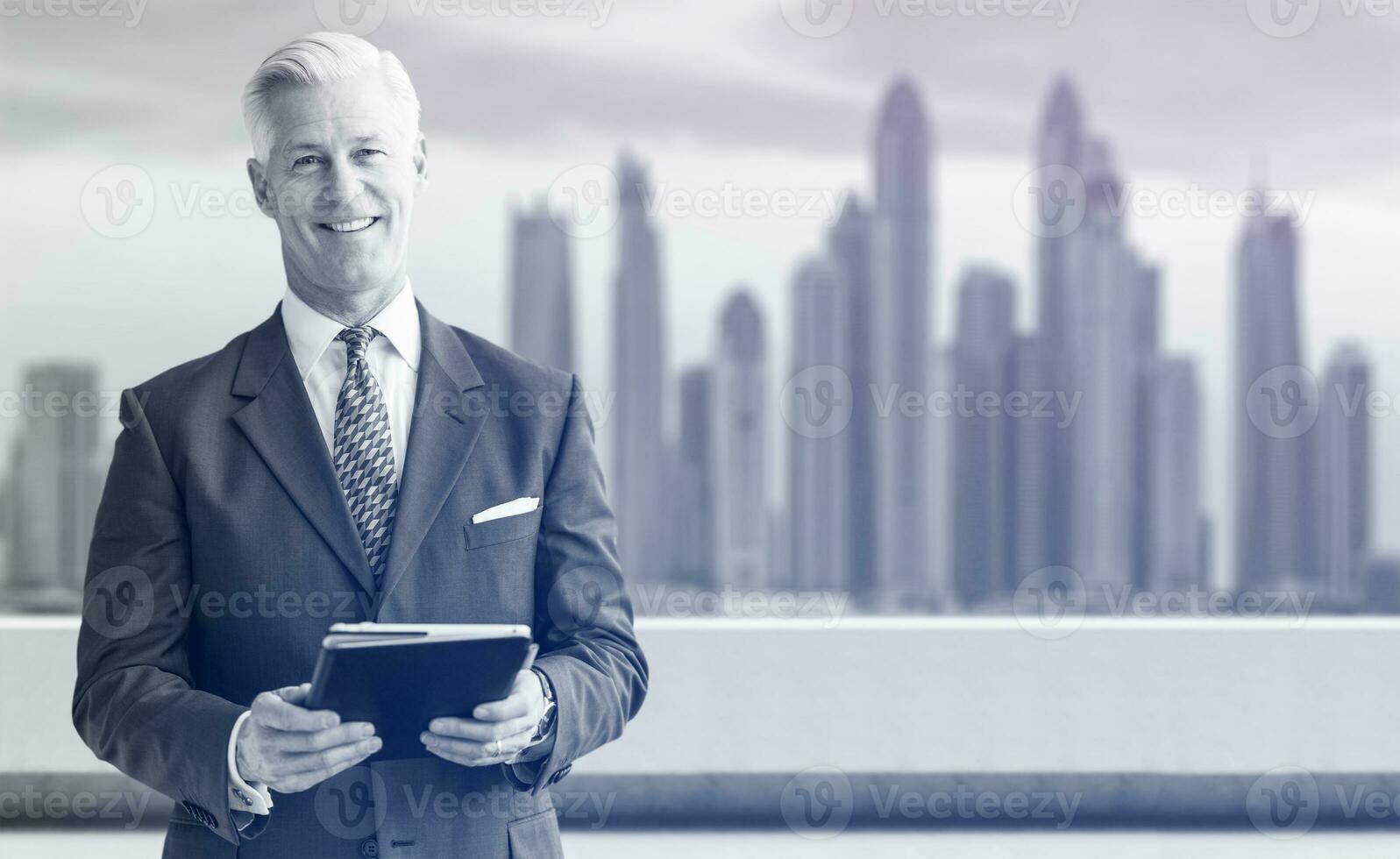 Senior businessman in front of the big city photo
