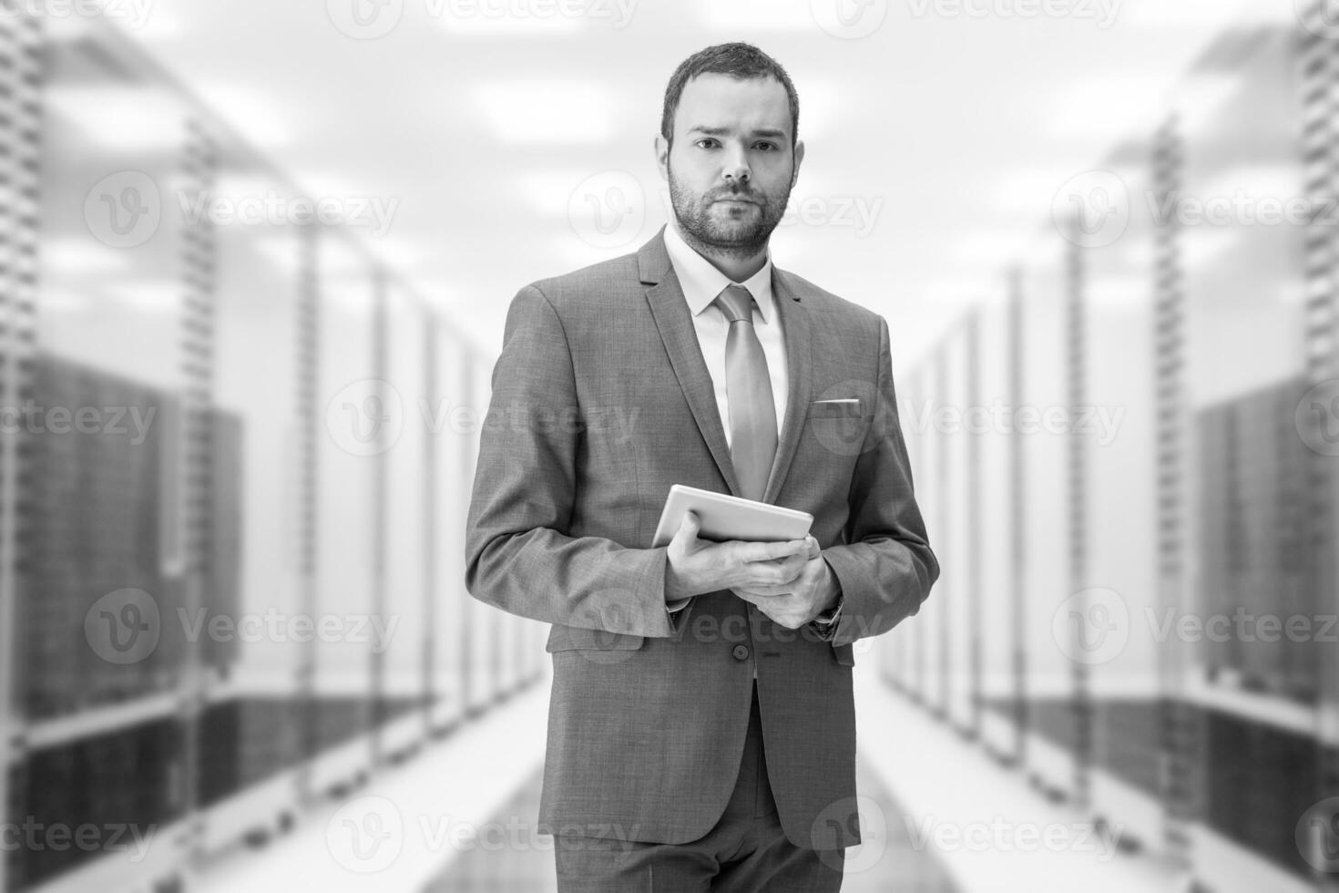 Young businessman in server room photo