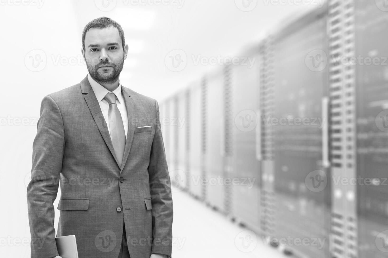 Young businessman in server room photo