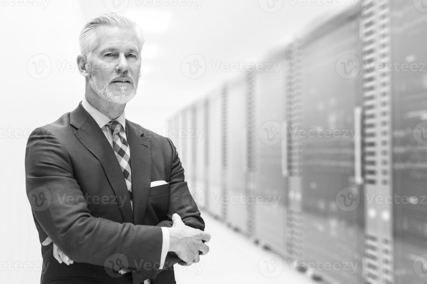 Senior businessman in server room photo