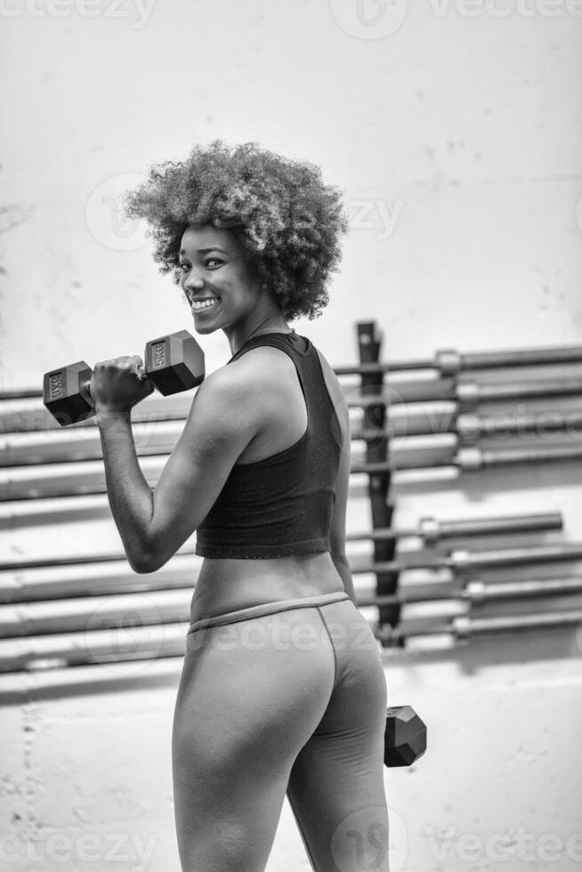 black woman doing bicep curls photo