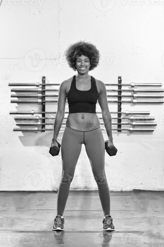 black woman doing bicep curls photo
