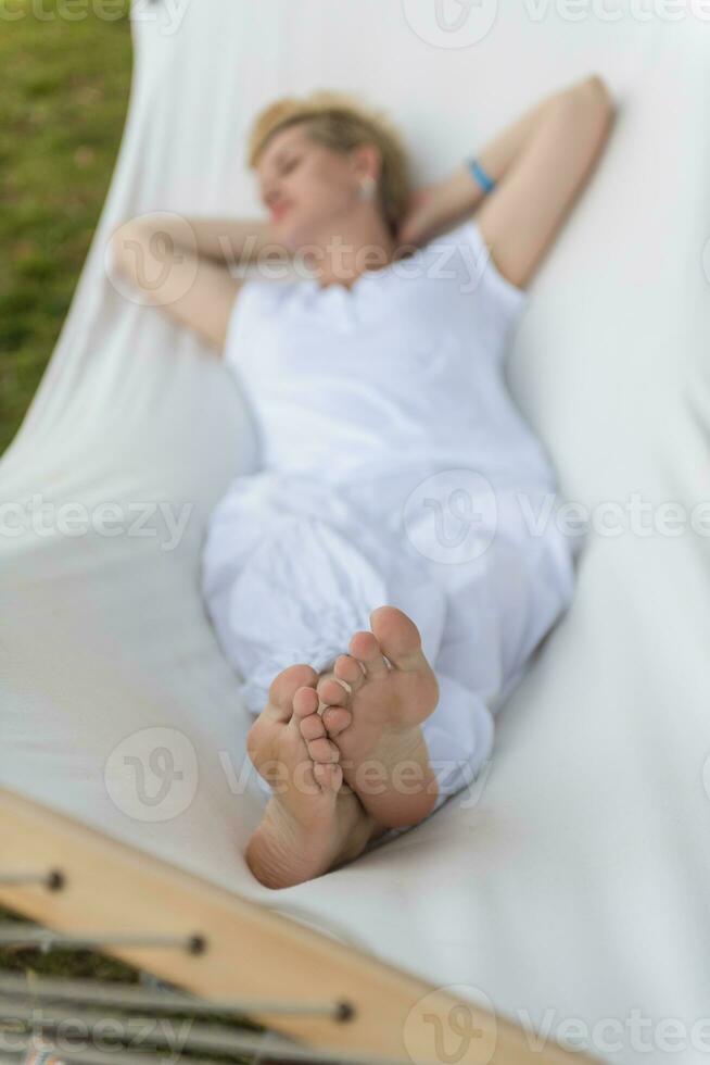 young woman resting on hammock photo