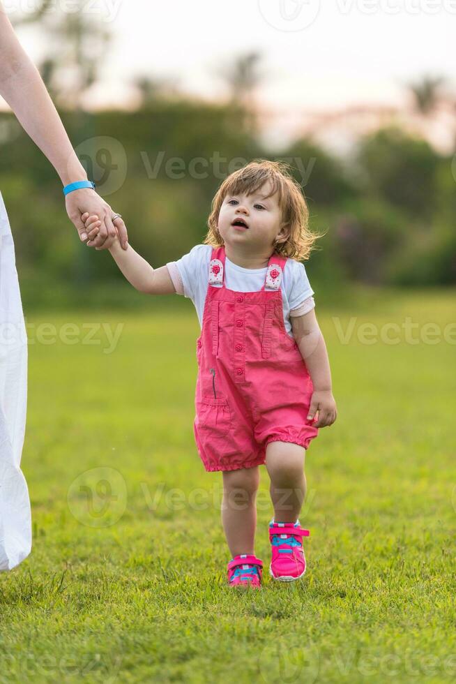 mother and little daughter playing at backyard photo