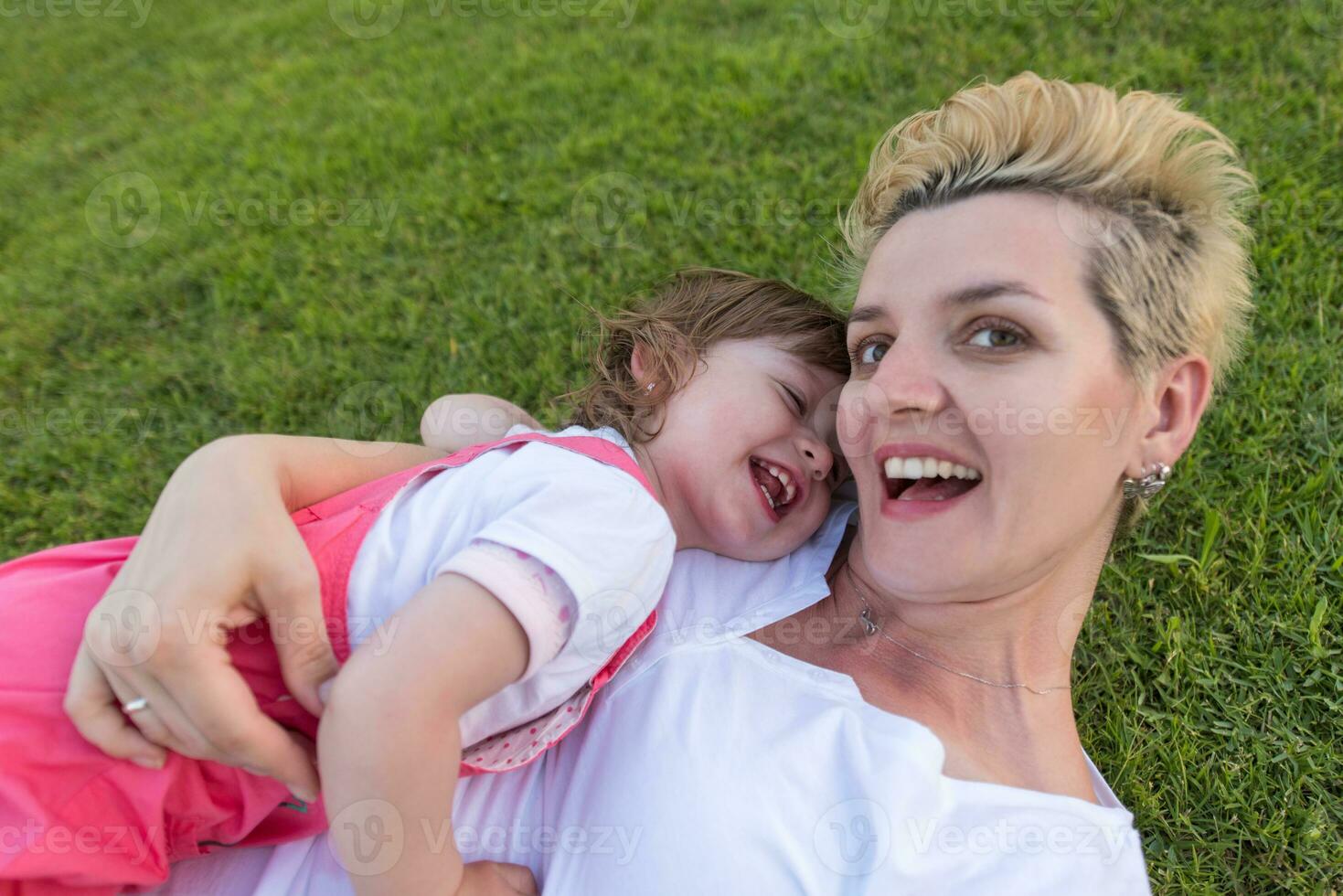 mother and little daughter playing at backyard photo