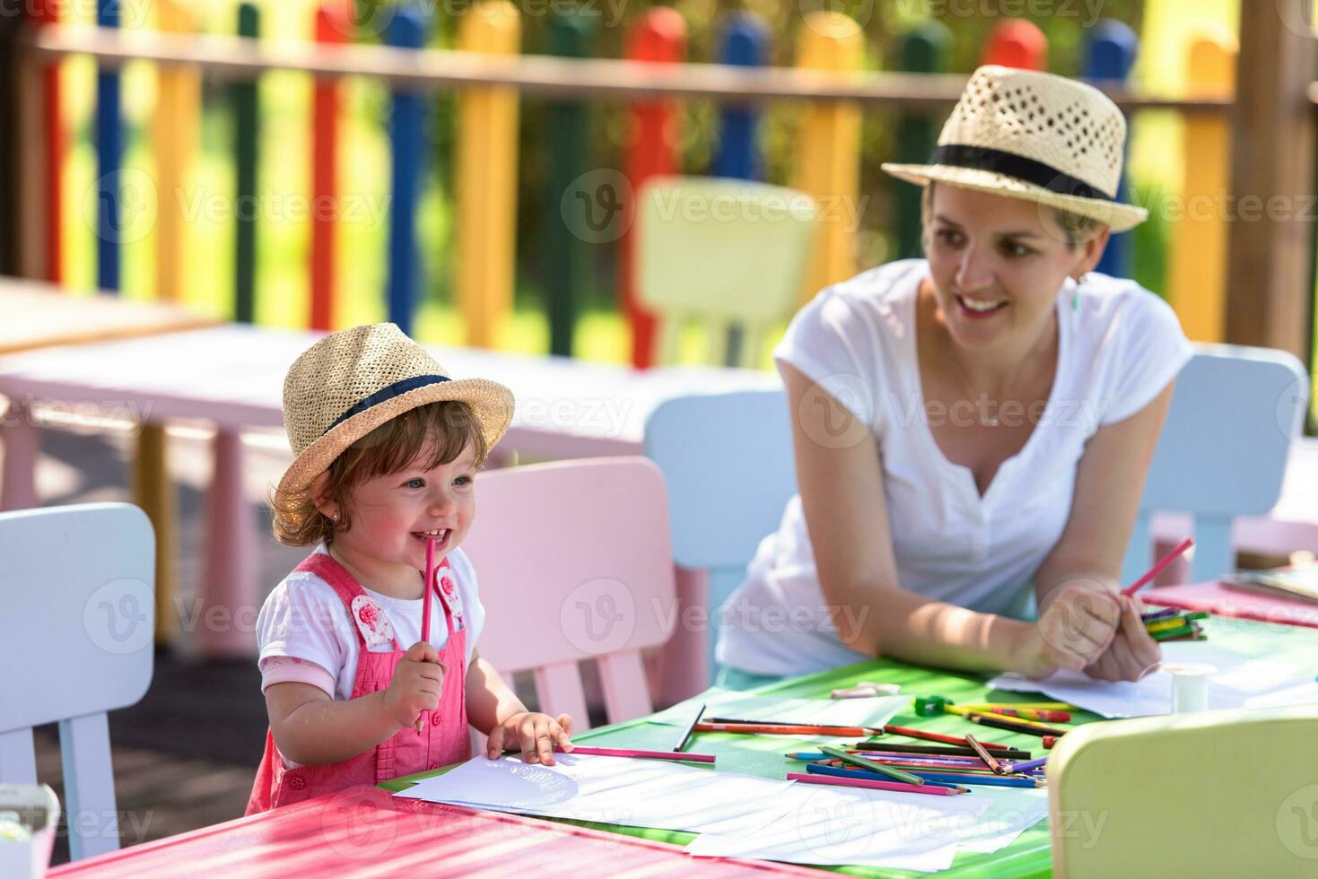 mom and little daughter drawing a colorful pictures photo