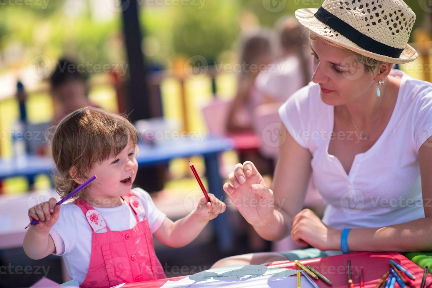 mom and little daughter drawing a colorful pictures photo