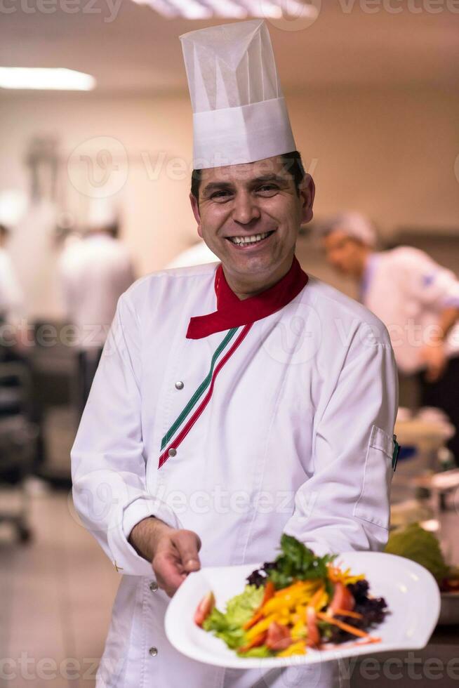 Chef showing a plate of tasty meal photo
