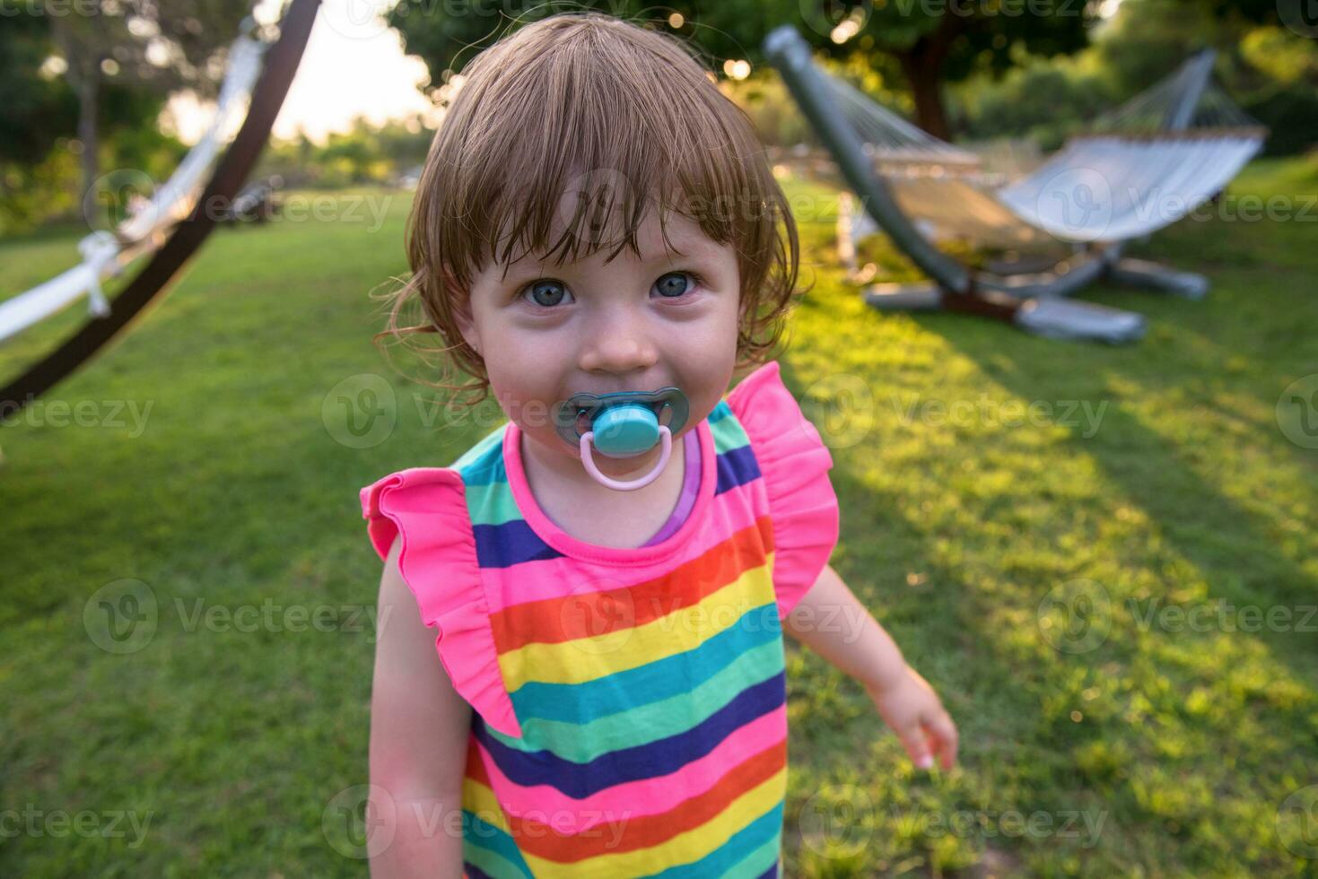 little girl spending time at backyard photo