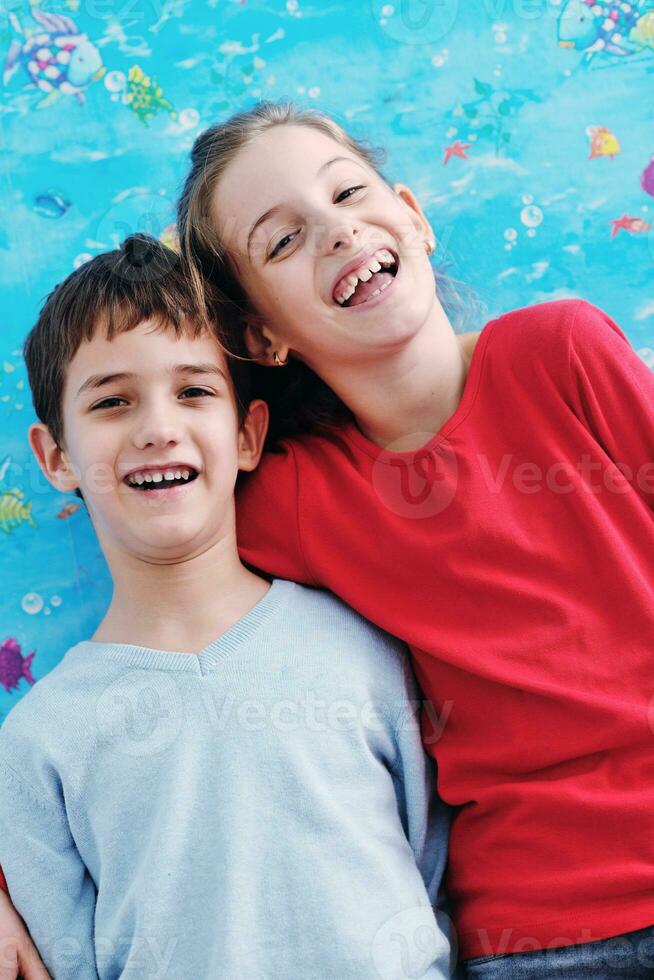 portrait of happy brother and sister at home photo