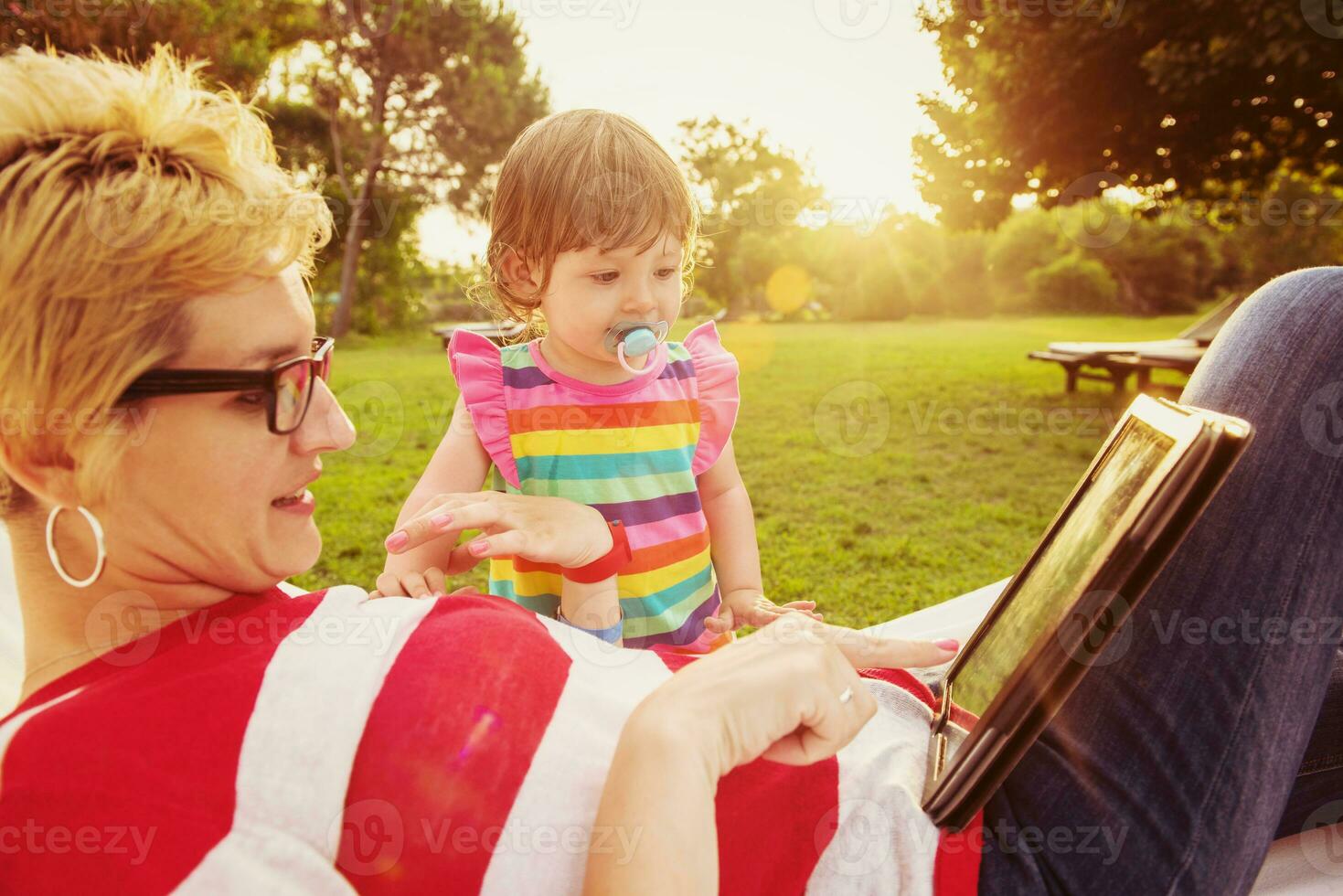 mom and a little daughter relaxing in a hammock photo