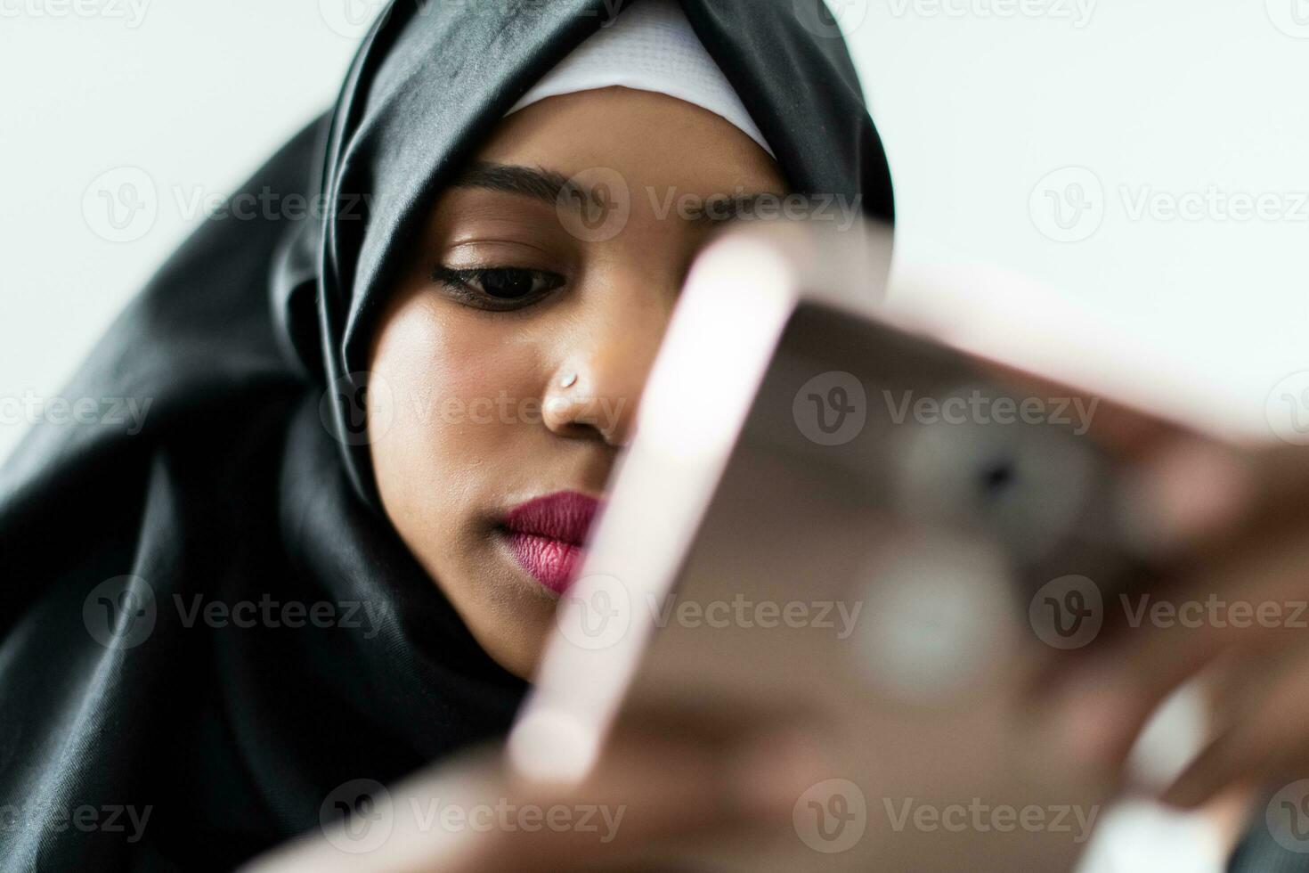 African American woman using a smartphone and browsing social media during a pandemic photo