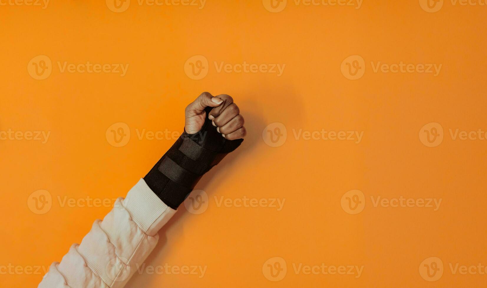 isolated hurt hand of African American girl on yellow background photo