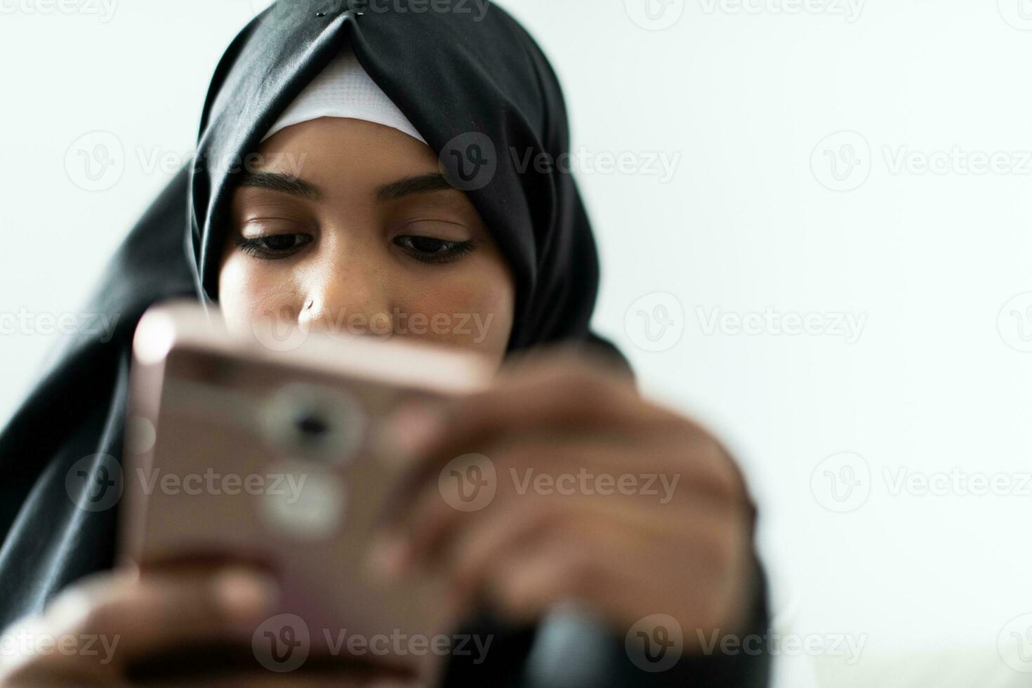 African American woman using a smartphone and browsing social media during a pandemic photo