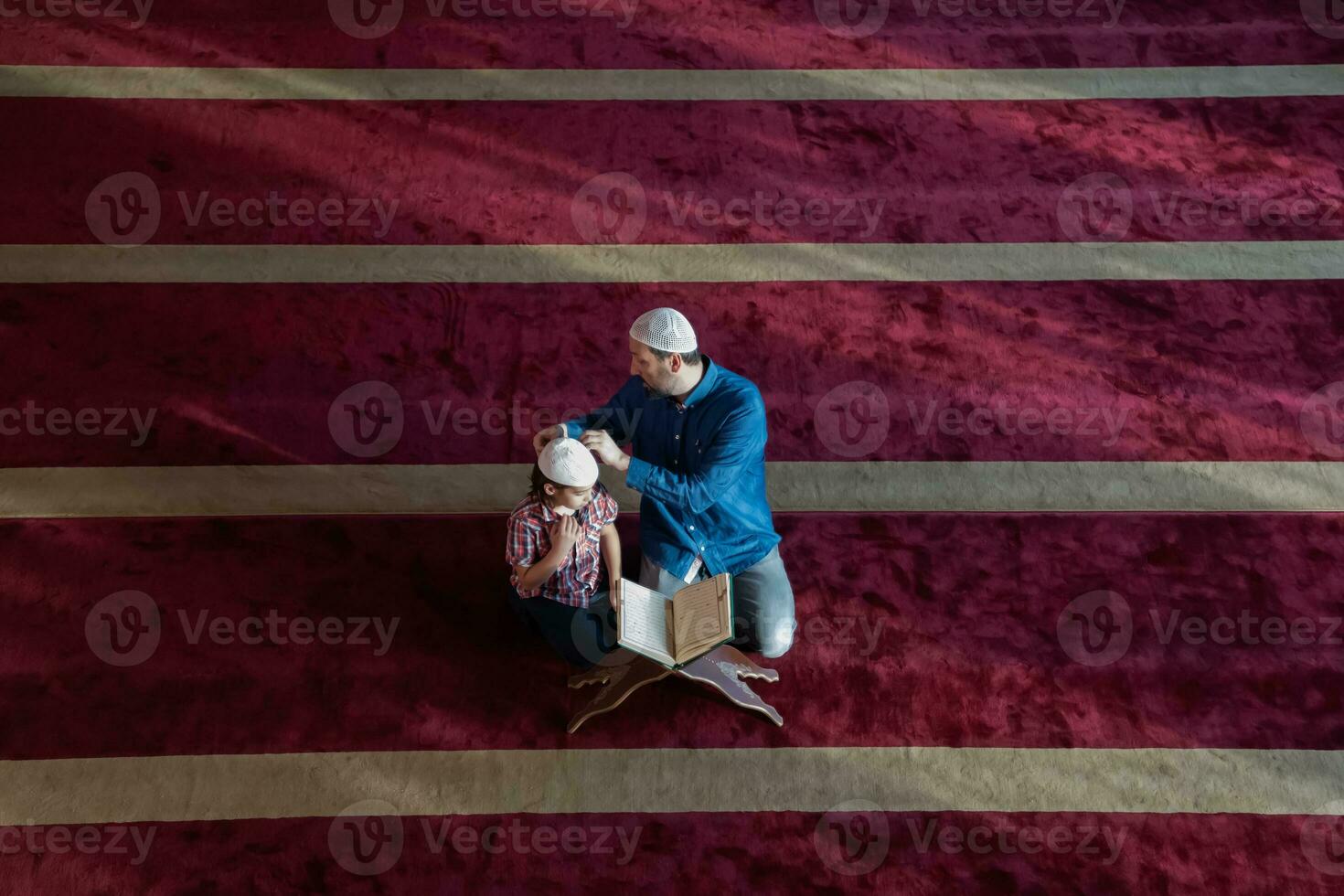 muslim prayer father and son in mosque praying and reading holly book quran together islamic education concept photo