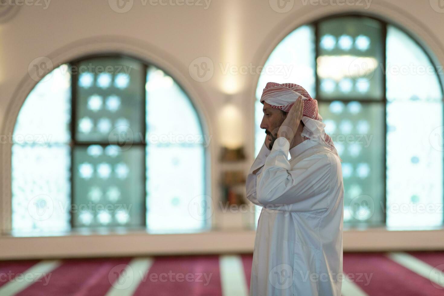a Muslim begins to offer prayer by raising his hands in the air, a calm state in prayer photo