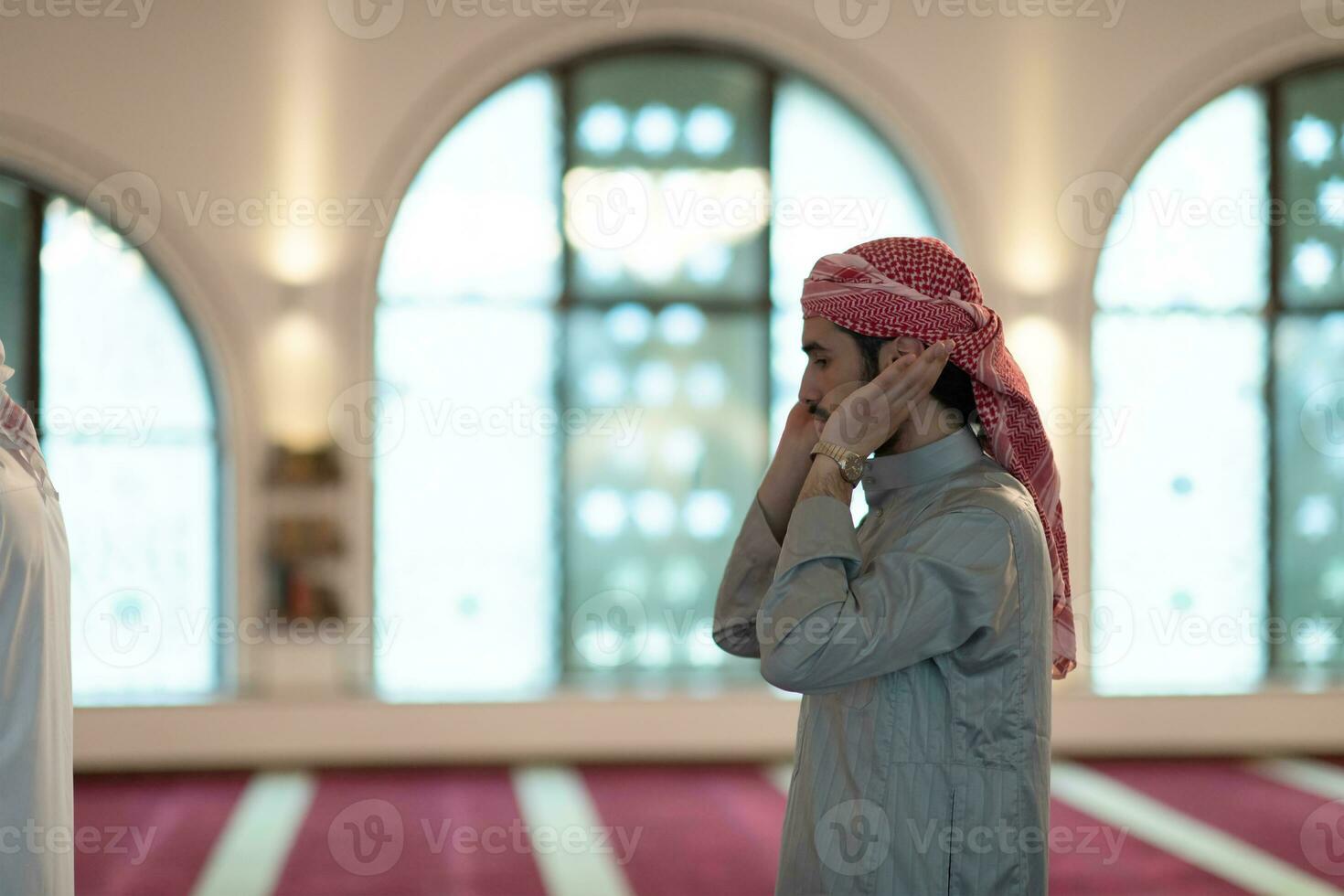 a Muslim begins to offer prayer by raising his hands in the air, a calm state in prayer photo