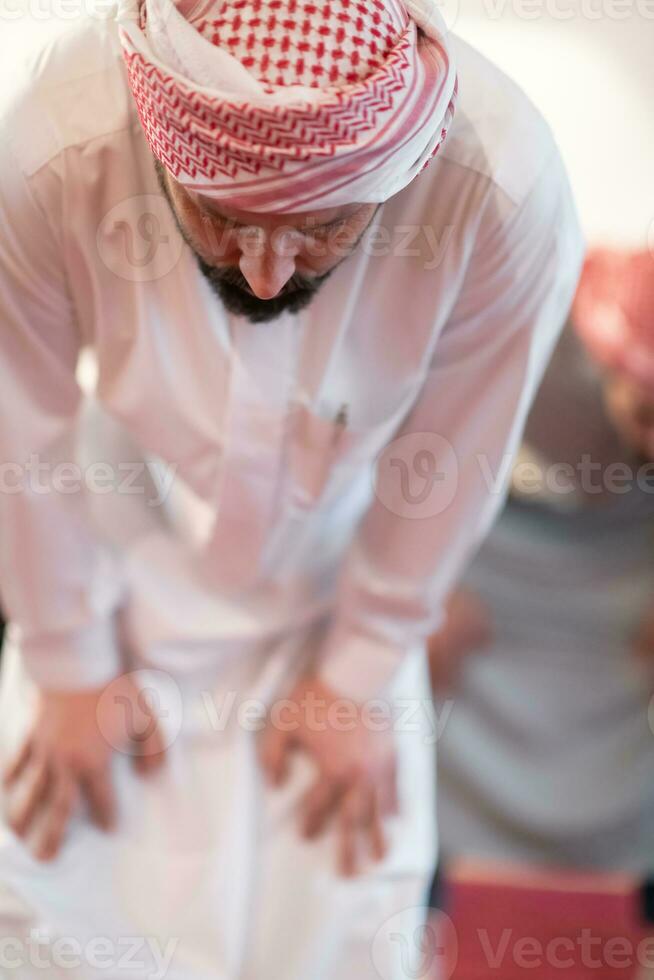 group of muslim people praying namaz in mosque. photo