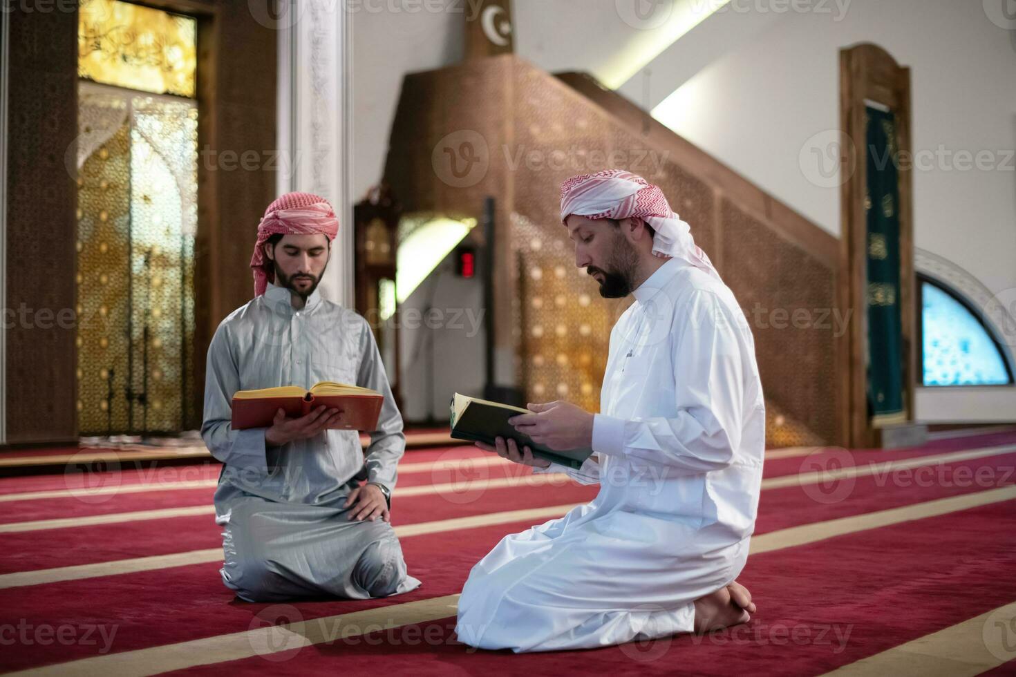 two muslim people in mosque reading quran together concept of islamic education photo