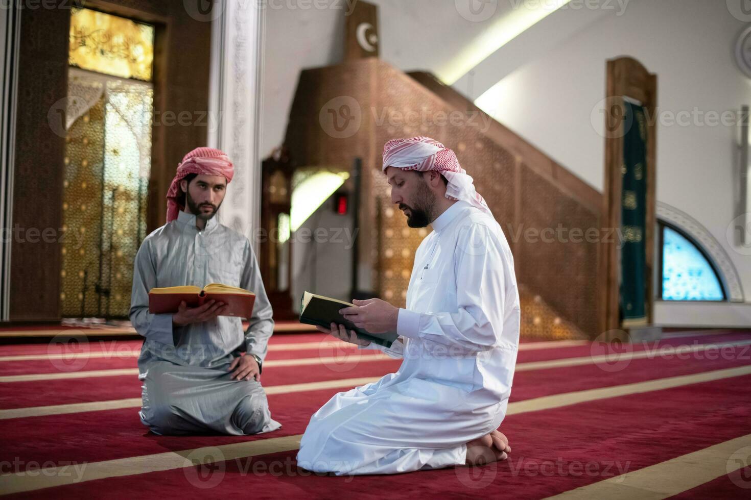 two muslim people in mosque reading quran together concept of islamic education photo