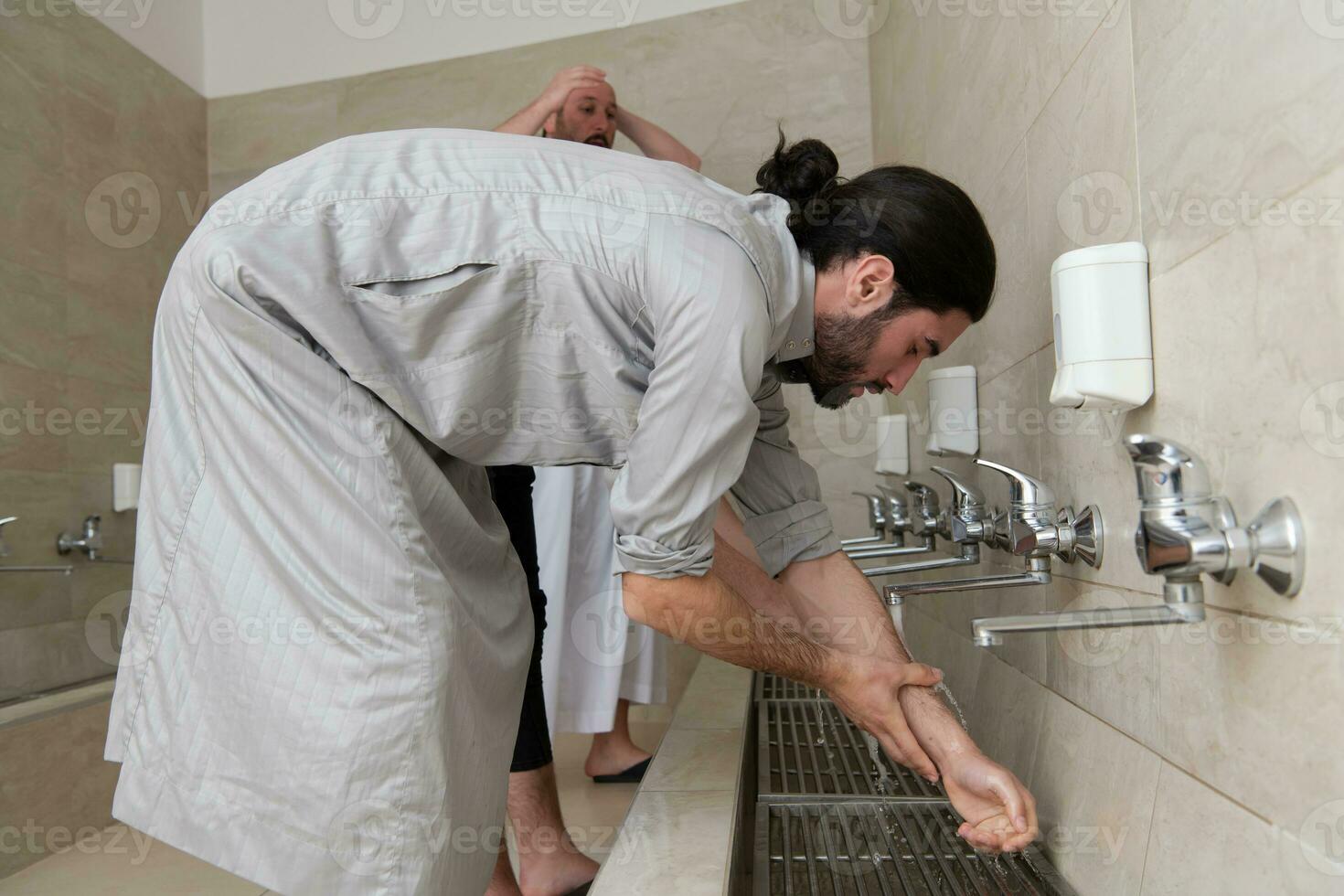 a group of Muslims take ablution for prayer. Islamic religious rite photo
