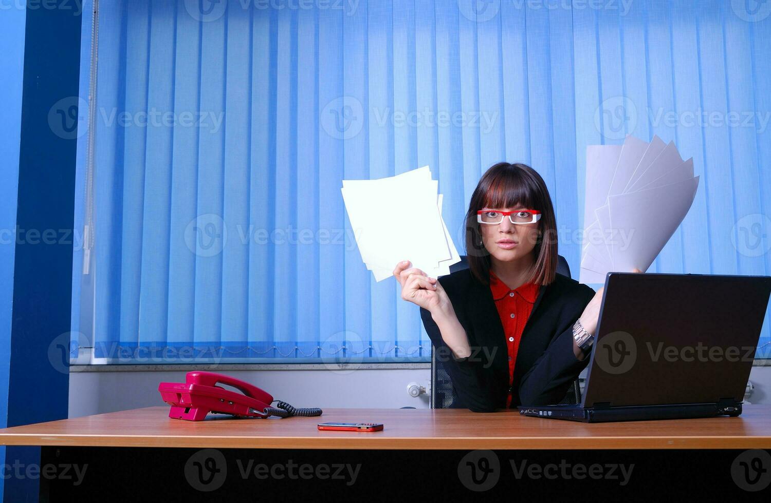 .angry businesswoman holding documents photo