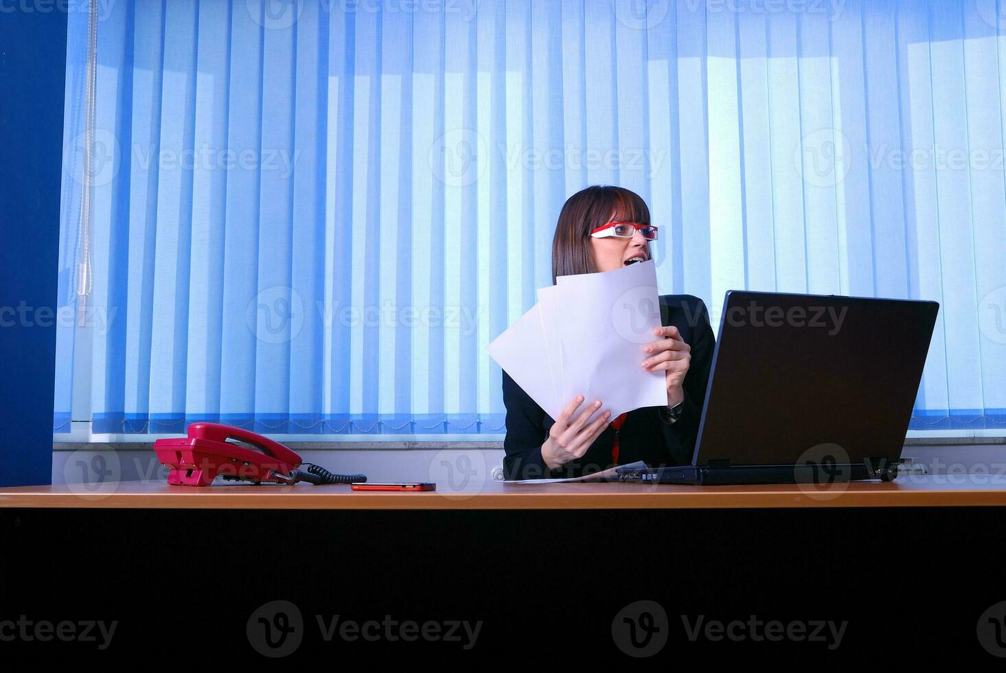 .angry businesswoman holding documents photo