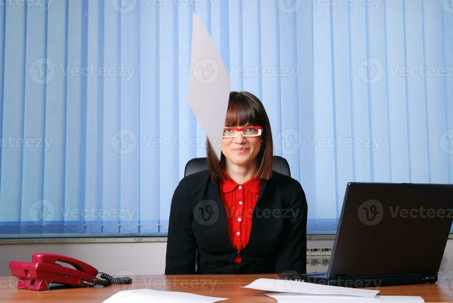 Happy businesswoman throwing documents photo