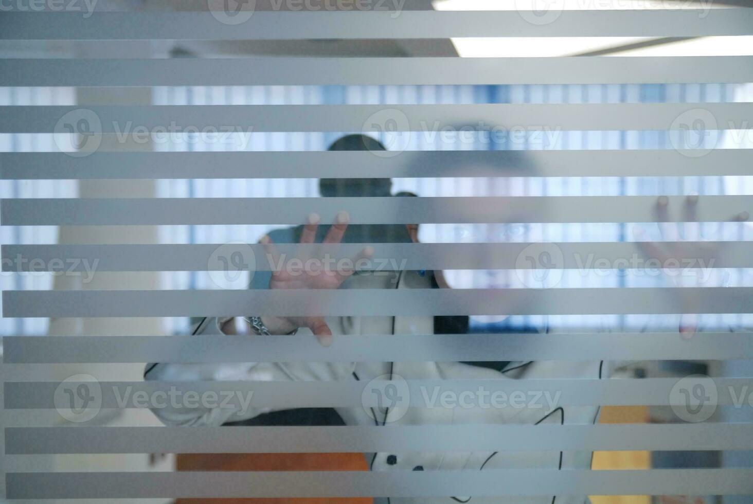 young businesswoman looking trought transparent wall photo
