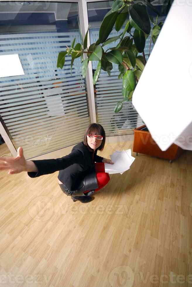 happy businesswoman throwing documents in office photo