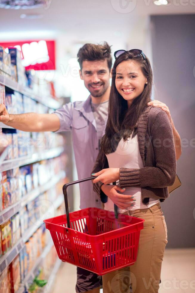 couple shopping in a supermarket photo