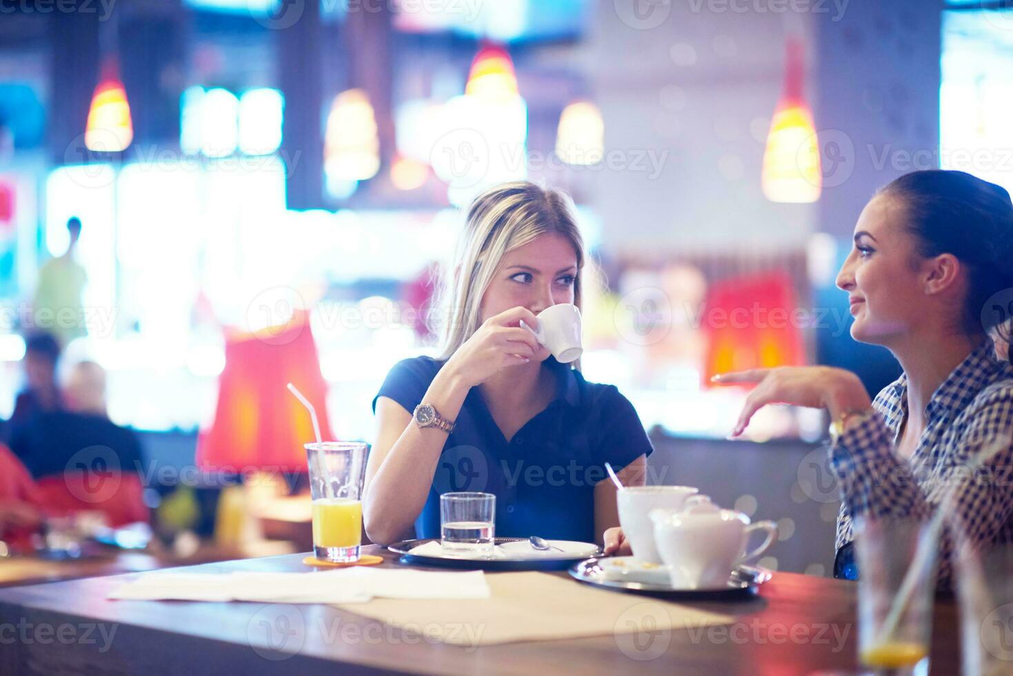 girls have cup of coffee in restaurant photo