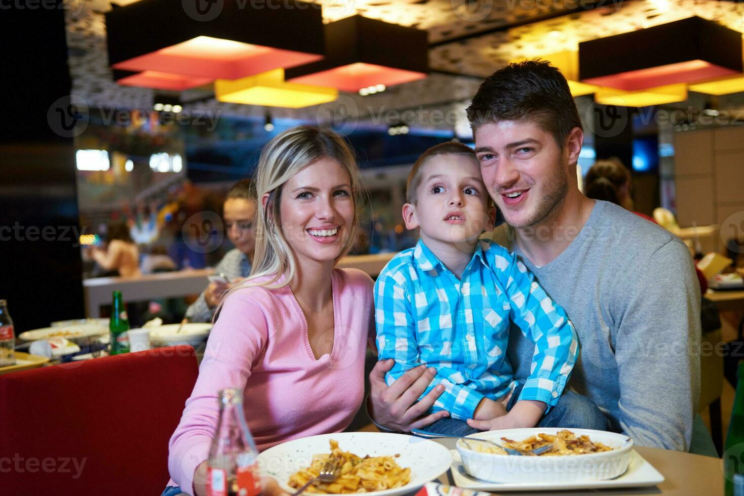 family having lunch in shopping mall photo