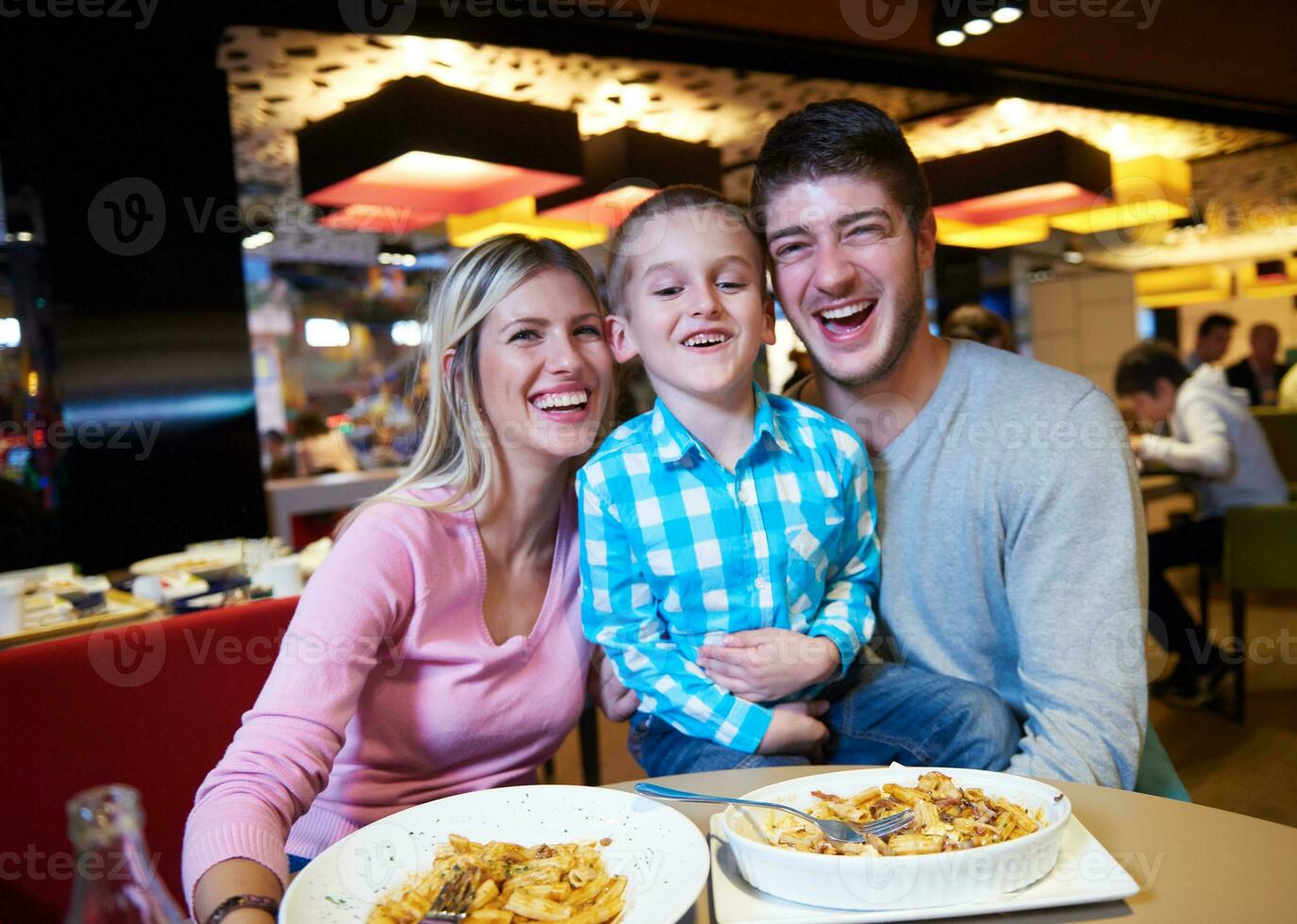 family having lunch in shopping mall photo