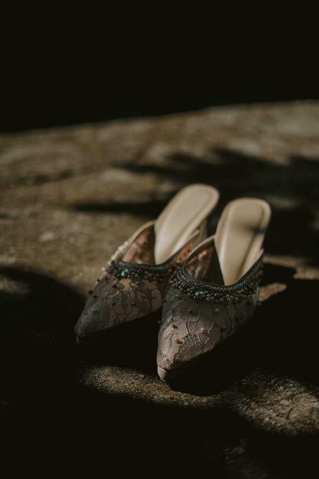 a pair of wedding shoes on the ground photo