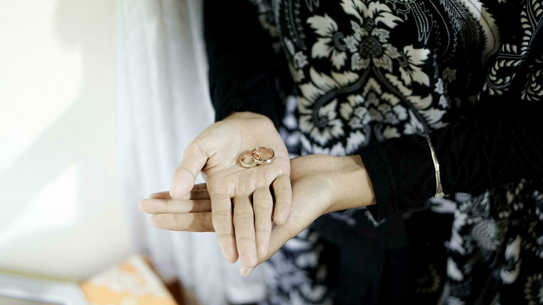 a woman holding a pair of rings in her hands photo
