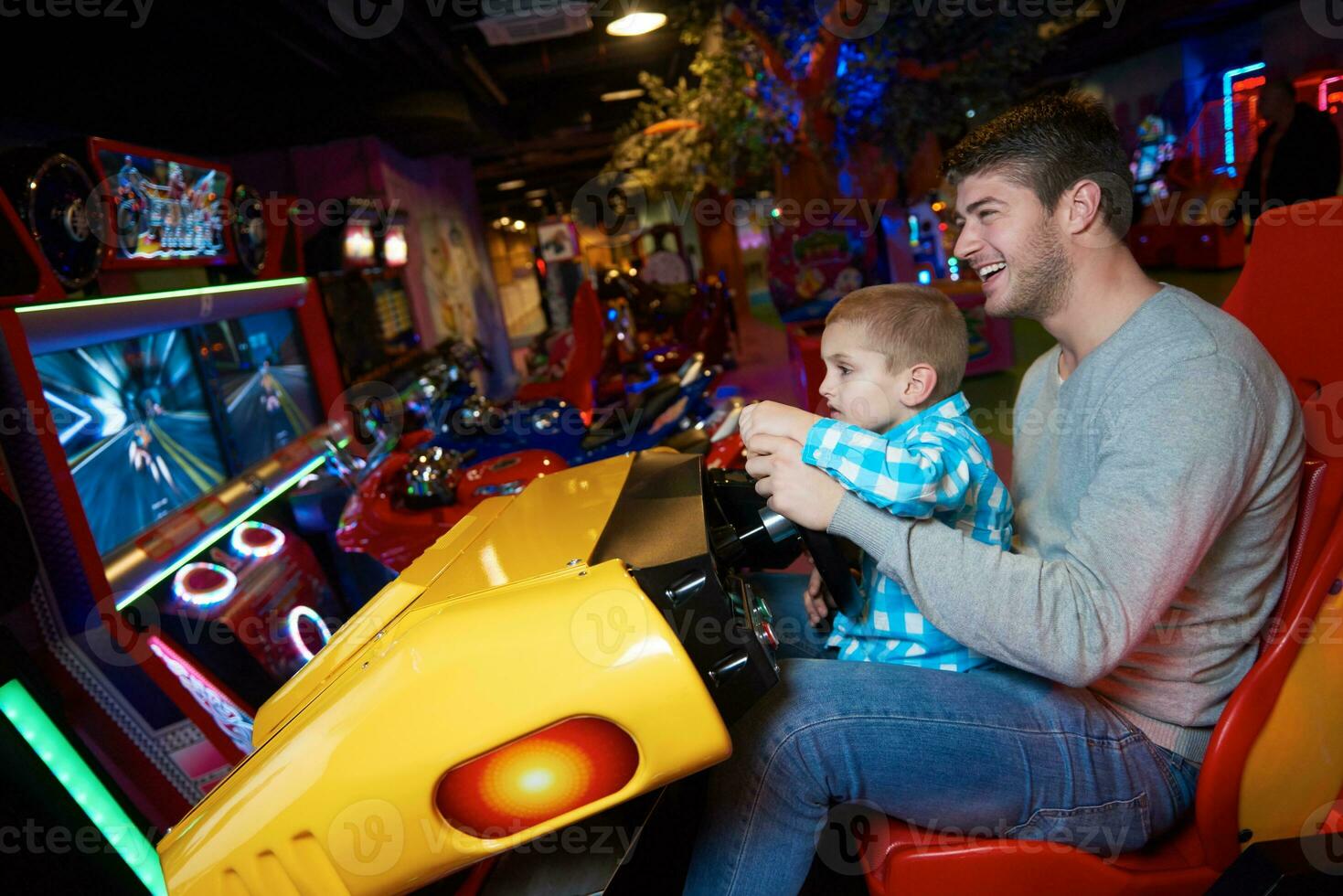 father and son playing game in playground photo