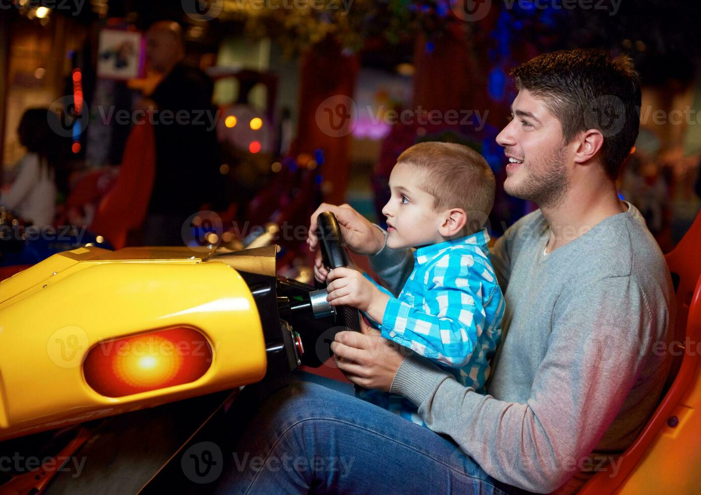 father and son playing game in playground photo